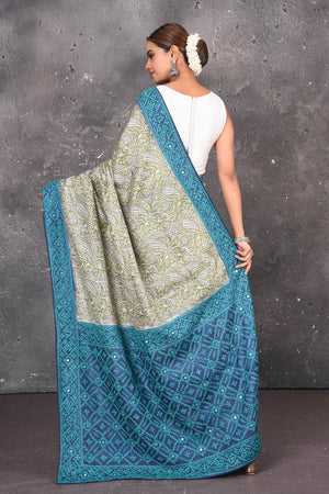 Buy this exquisite hand block printed designer saree in silver-grey and blue color with kutch work online in USA.  Add this hand-embroidered tussar sari which has made up of pure tussar silk. These sarees can be worn for any occasion - It carries a class. Buy this tussar sari with any blouse from Pure Elegance Indian saree store in USA.-Back view with open pallu.