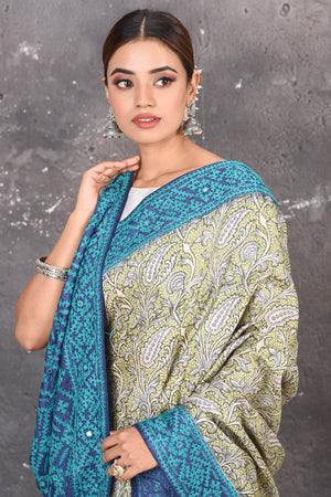 Buy this exquisite hand block printed designer saree in silver-grey and blue color with kutch work online in USA.  Add this hand-embroidered tussar sari which has made up of pure tussar silk. These sarees can be worn for any occasion - It carries a class. Buy this tussar sari with any blouse from Pure Elegance Indian saree store in USA.- Close up.