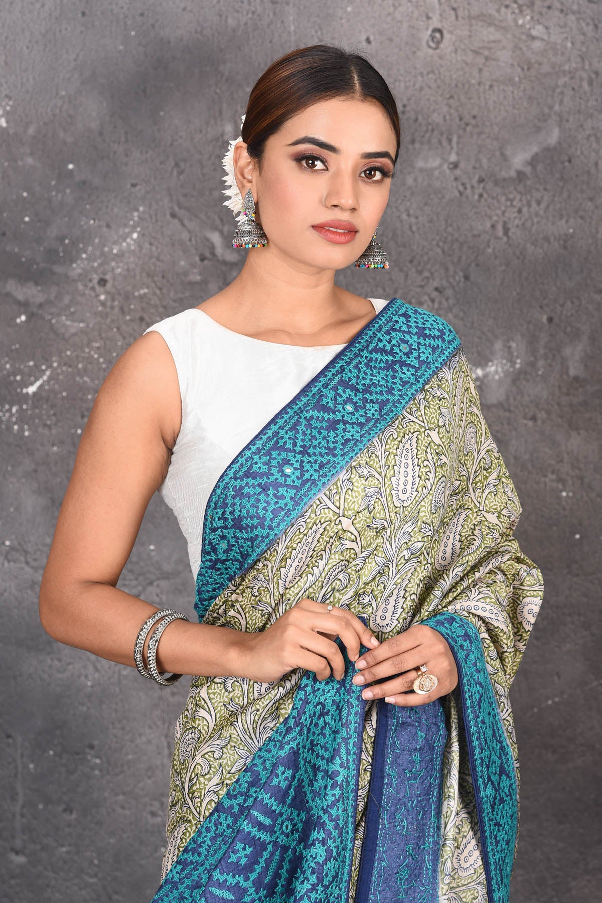Buy this exquisite hand block printed designer saree in silver-grey and blue color with kutch work online in USA.  Add this hand-embroidered tussar sari which has made up of pure tussar silk. These sarees can be worn for any occasion - It carries a class. Buy this tussar sari with any blouse from Pure Elegance Indian saree store in USA.- Close up.