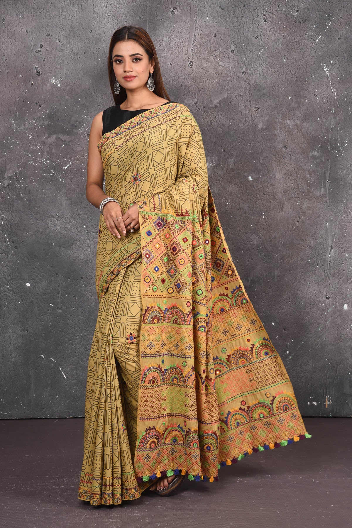 Shop this classy mustard yellow hand painted madhubani cotton saree online in USA. Perfect to be worn as part of your everyday work wear, with this hand-painted Mustard Yellow Madhubani saree, elegance meets traditional. Add this designer Lambani embroidery designer saree to your collection from Pure Elegance Indian Fashion Store in USA.- Full view with open pallu.