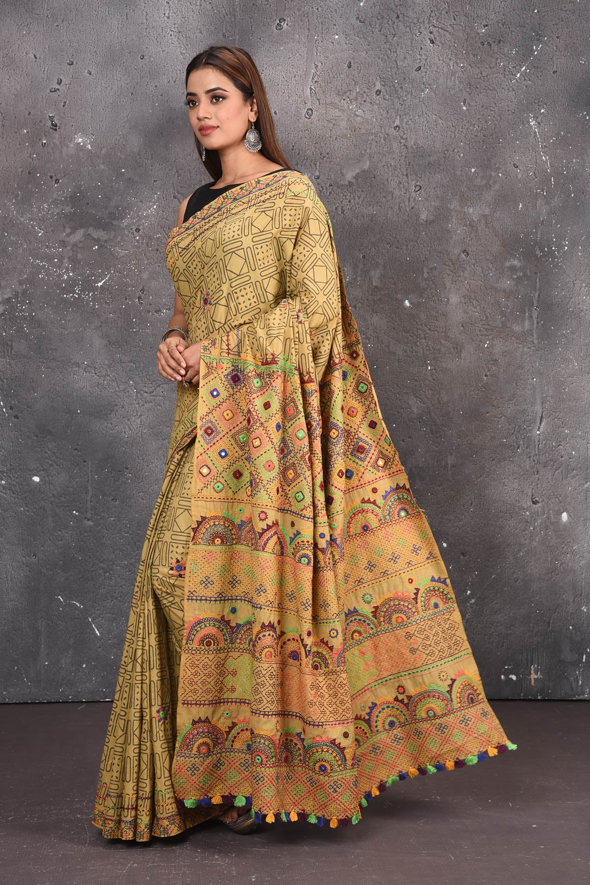 Shop this classy mustard yellow hand painted madhubani cotton saree online in USA. Perfect to be worn as part of your everyday work wear, with this hand-painted Mustard Yellow Madhubani saree, elegance meets traditional. Add this designer Lambani embroidery designer saree to your collection from Pure Elegance Indian Fashion Store in USA.- Side view.