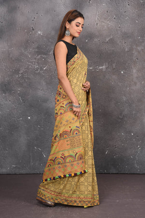 Shop this classy mustard yellow hand painted madhubani cotton saree online in USA. Perfect to be worn as part of your everyday work wear, with this hand-painted Mustard Yellow Madhubani saree, elegance meets traditional. Add this designer Lambani embroidery designer saree to your collection from Pure Elegance Indian Fashion Store in USA.- Side view.