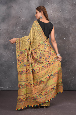 Shop this classy mustard yellow hand painted madhubani cotton saree online in USA. Perfect to be worn as part of your everyday work wear, with this hand-painted Mustard Yellow Madhubani saree, elegance meets traditional. Add this designer Lambani embroidery designer saree to your collection from Pure Elegance Indian Fashion Store in USA.- Back view with open pallu.