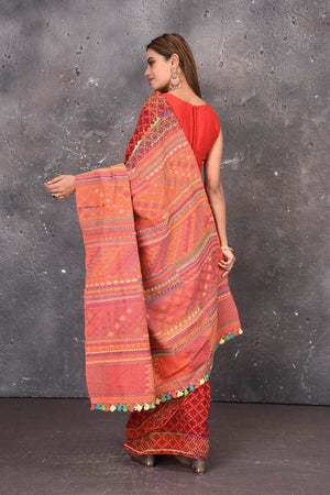 Shop this classy red hand painted madhubani cotton saree online in USA. Perfect to be worn as part of your everyday work wear, with this hand-painted red Madhubani saree, elegance meets traditional. Add this designer Lambani embroidery designer saree with colored tassels to your collection from Pure Elegance Indian Fashion Store in USA.- Back view with open pallu.