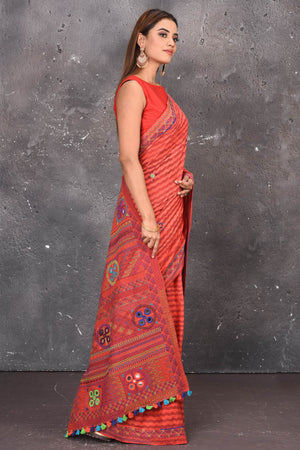 Buy this classy red hand painted madhubani cotton leheriya pattern saree online in USA. Perfect to be worn as part of your everyday work wear, with this hand-painted red Madhubani saree, elegance meets traditional. Add this designer Lambani embroidery designer saree with colored tassels to your collection from Pure Elegance Indian Fashion Store in USA.- Side view.