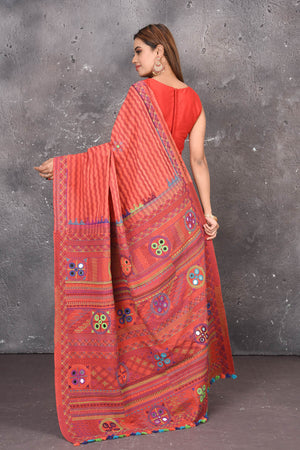 Buy this classy red hand painted madhubani cotton leheriya pattern saree online in USA. Perfect to be worn as part of your everyday work wear, with this hand-painted red Madhubani saree, elegance meets traditional. Add this designer Lambani embroidery designer saree with colored tassels to your collection from Pure Elegance Indian Fashion Store in USA.- Back view with open pallu.