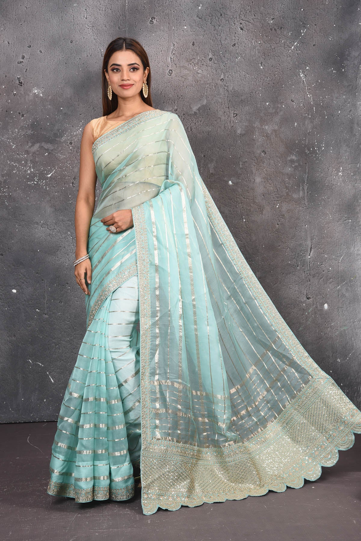 Buy this exquisite firozi blue saree in organza with striped print and silver embroidered border online in USA which is made of organza fabric and lightweight. This organza Saree is beautified with printed work and latest trend. Ideal for casual, kitty parties, stylish accessories. Shop this from Pure Elegance Indian fashion store in USA.- Full view.