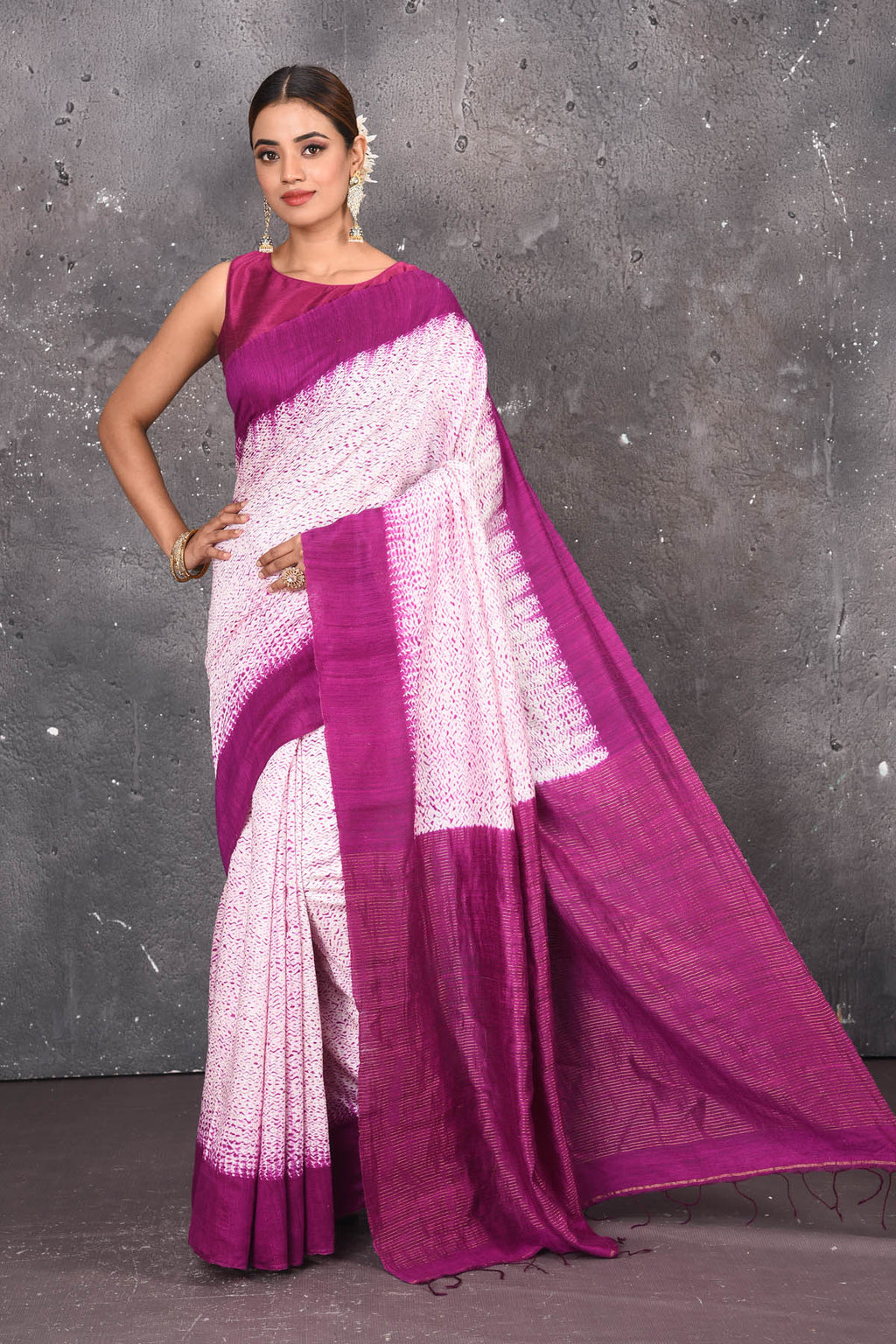 Shop this elegant offwhite-purple handloom shibori tussar saree online in USA which is handcrafted from fine silk tussar fabric, this tie and dye saree brings out the nature of flow. You can pair this beautiful shibori print with minimal jewellery for a casual day outfit. Add this plain shibori saree to your collection from Pure Elegance Indian fashion store in USA.- Full view.