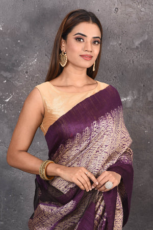 Shop this elegant purple-gold handloom shibori tussar saree online in USA which is handcrafted from fine silk tussar fabric, this tie and dye saree brings out the nature of flow. You can pair this beautiful shibori print with minimal jewellery for a casual day outfit. Add this plain shibori saree to your collection from Pure Elegance Indian fashion store in USA.-Close up.