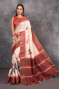 Buy this elegant offwhite-red pure tussar saree with floral embroidered hand cutwork border online in USA which is handcrafted from fine silk tussar fabric, this tie and dye saree brings out the nature of flow. You can pair this beautiful floral embroidered print saree with minimal jewellery for a casual day outfit. Add this pure tussar saree to your collection from Pure Elegance Indian fashion store in USA.-Full view.