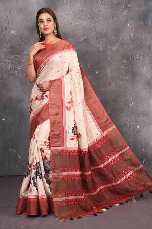 Buy this elegant offwhite-red pure tussar saree with floral embroidered hand cutwork border online in USA which is handcrafted from fine silk tussar fabric, this tie and dye saree brings out the nature of flow. You can pair this beautiful floral embroidered print saree with minimal jewellery for a casual day outfit. Add this pure tussar saree to your collection from Pure Elegance Indian fashion store in USA.-Full view with open pallu.