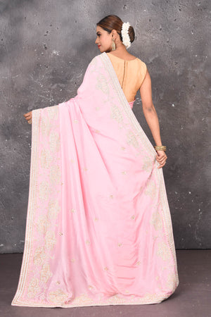 Shop this elegant baby pink gota patti mirror embroidered soft organza silk designer saree online in USA with colourful threadwork of flowers, gota patti leaves and dazzling cut dana and mirror work details. Mirror bootis are scattered all over the saree to match the brightness of the happy pink look. Add this designer sari to your collection from Pure Elegance Indian fashion store in USA.-Back view with open pallu.