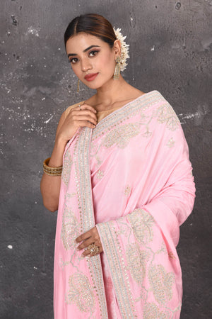 Shop this elegant baby pink gota patti mirror embroidered soft organza silk designer saree online in USA with colourful threadwork of flowers, gota patti leaves and dazzling cut dana and mirror work details. Mirror bootis are scattered all over the saree to match the brightness of the happy pink look. Add this designer sari to your collection from Pure Elegance Indian fashion store in USA.-Close up.