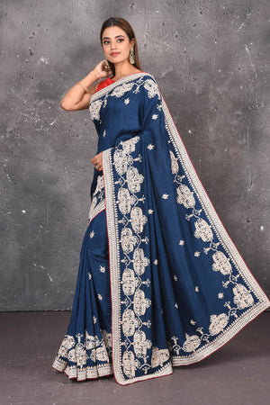 Buy this elegant navy blue gota patti mirror embroidered soft organza silk designer saree online in USA with colourful threadwork of flowers, gota patti leaves and dazzling cut dana and mirror work details. Mirror bootis are scattered all over the saree to match the brightness of the happy look. Add this designer sari to your collection from Pure Elegance Indian fashion store in USA.-Side view with open pallu.