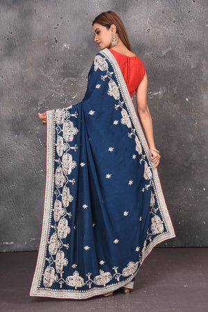 Buy this elegant navy blue gota patti mirror embroidered soft organza silk designer saree online in USA with colourful threadwork of flowers, gota patti leaves and dazzling cut dana and mirror work details. Mirror bootis are scattered all over the saree to match the brightness of the happy look. Add this designer sari to your collection from Pure Elegance Indian fashion store in USA.-Back view with open pallu.