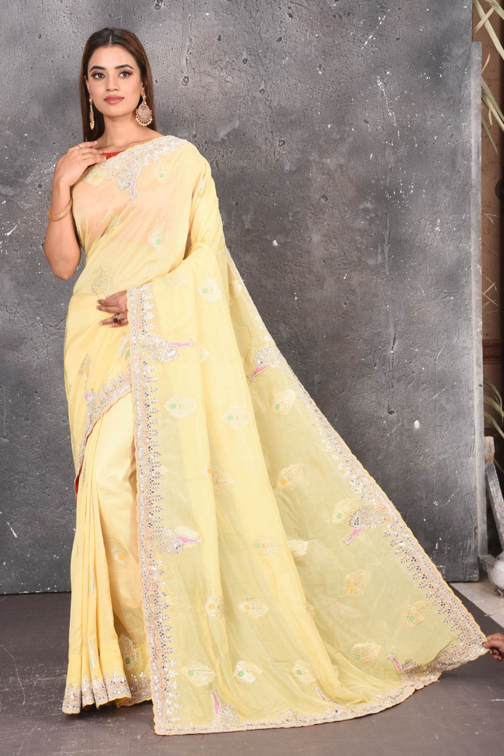 Buy this elegant lemon yellow gota patti mirror embroidered soft organza silk designer saree online in USA with beautiful peacock design threadwork, gota patti leaves and dazzling cut dana and mirror work details. Mirror bootis are scattered all over the saree to match the brightness of the happy look. Add this designer sari to your collection from Pure Elegance Indian fashion store in USA.-Full view.