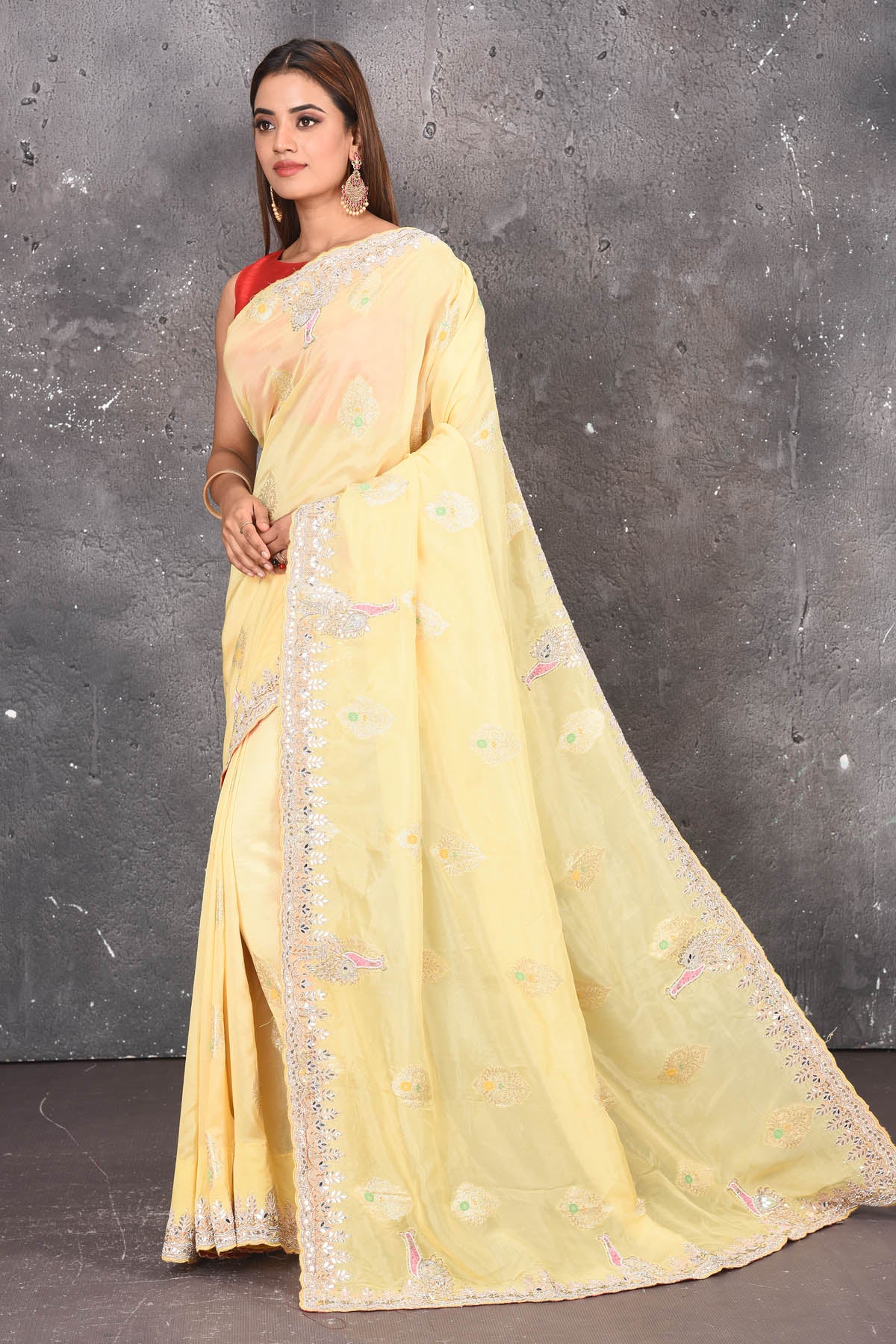 Buy this elegant lemon yellow gota patti mirror embroidered soft organza silk designer saree online in USA with beautiful peacock design threadwork, gota patti leaves and dazzling cut dana and mirror work details. Mirror bootis are scattered all over the saree to match the brightness of the happy look. Add this designer sari to your collection from Pure Elegance Indian fashion store in USA.-Side view with open pallu.