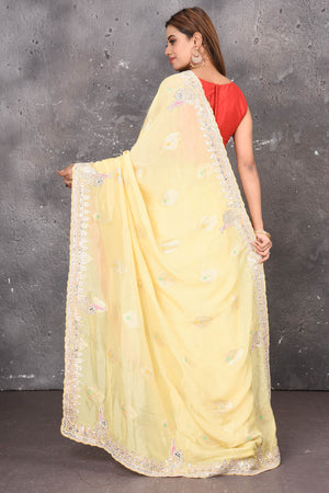 Buy this elegant lemon yellow gota patti mirror embroidered soft organza silk designer saree online in USA with beautiful peacock design threadwork, gota patti leaves and dazzling cut dana and mirror work details. Mirror bootis are scattered all over the saree to match the brightness of the happy look. Add this designer sari to your collection from Pure Elegance Indian fashion store in USA.-Back view with open pallu.