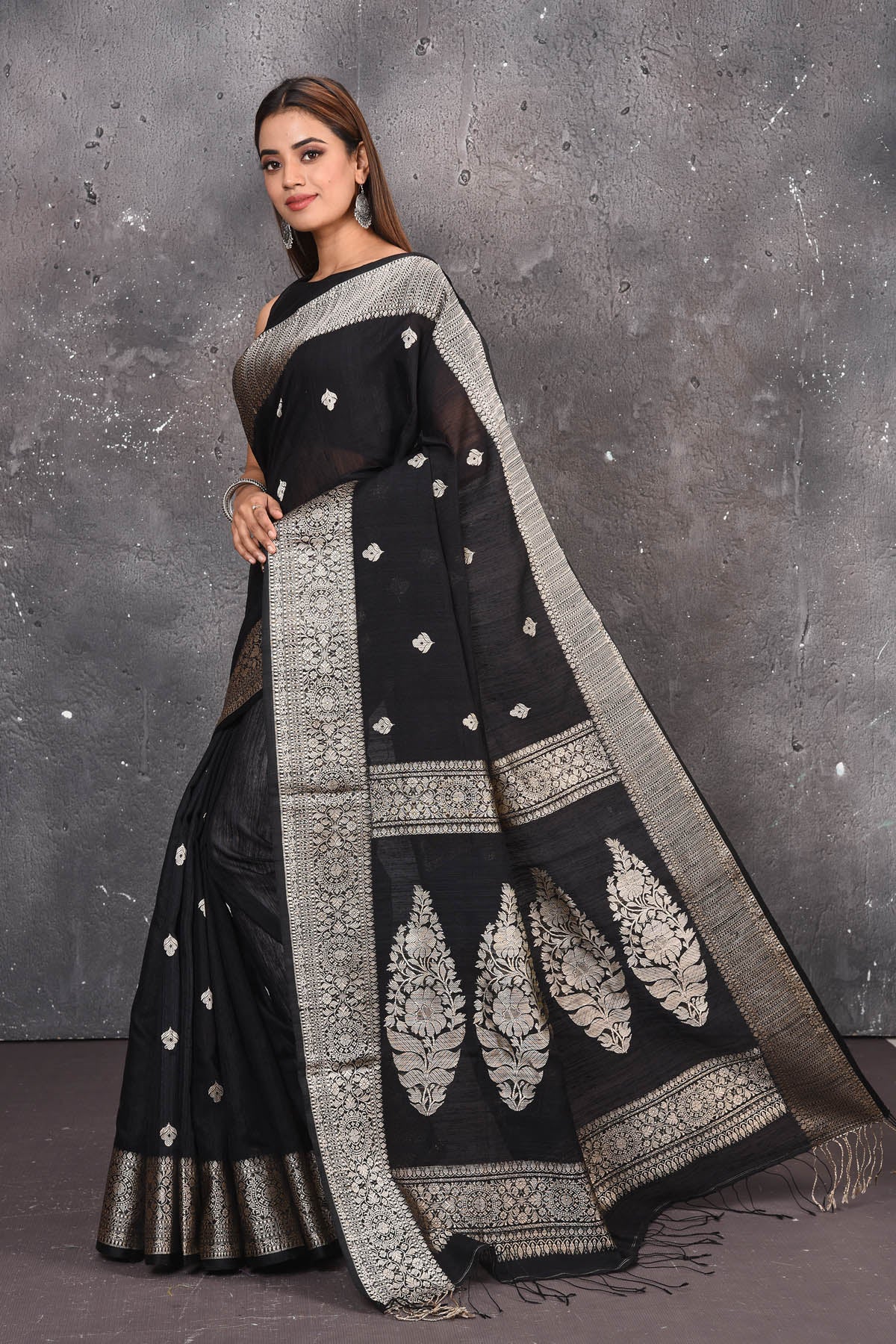 Buy elegant black zari woven matka Silk Banarasi saree with zari broad border online in USA which has crafted by skilled weaver of Banaras with elegance and grace, this saree is definitely the epitome of beauty and a must have in your collection. Buy designer handwoven banarasi brocade sari with any blouse from Pure Elegance Indian saree store in USA. -Side view with open pallu.