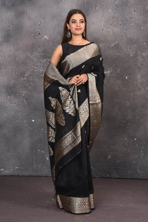 Buy elegant black zari woven matka Silk Banarasi saree with zari broad border online in USA which has crafted by skilled weaver of Banaras with elegance and grace, this saree is definitely the epitome of beauty and a must have in your collection. Buy designer handwoven banarasi brocade sari with any blouse from Pure Elegance Indian saree store in USA. -Front view with wrapped pallu.