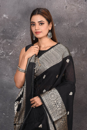 Buy elegant black zari woven matka Silk Banarasi saree with zari broad border online in USA which has crafted by skilled weaver of Banaras with elegance and grace, this saree is definitely the epitome of beauty and a must have in your collection. Buy designer handwoven banarasi brocade sari with any blouse from Pure Elegance Indian saree store in USA. -Close up.