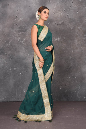 Buy exquisite pine green georgette banarasi designer saree with golden heavy Border online in USA which has crafted by skilled weaver of Banaras with elegance and grace, this saree is definitely the epitome of beauty and a must have in your collection. Buy designer handwoven banarasi georgette sari with any blouse from Pure Elegance Indian saree store in USA.-Side pallu.