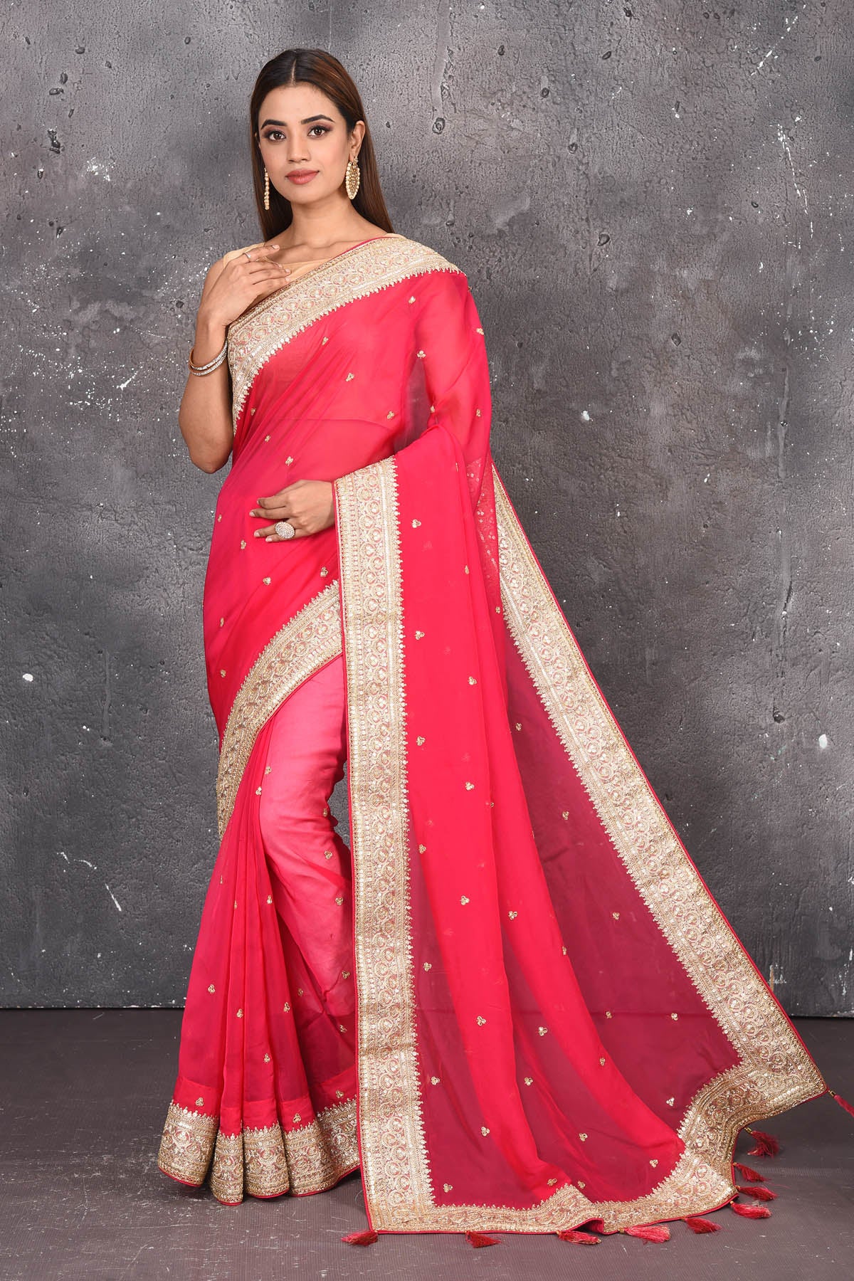 Shop exquisite pink georgette banarasi designer saree with golden heavy Border online in USA which has crafted by skilled weaver of Banaras with elegance and grace, this saree is definitely the epitome of beauty and a must have in your collection. Buy designer handwoven banarasi georgette sari with any blouse from Pure Elegance Indian saree store in USA.-Full view with open pallu.