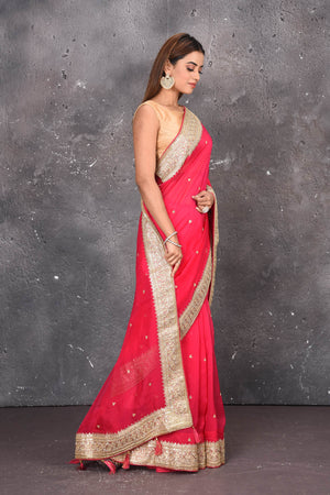 Shop exquisite pink georgette banarasi designer saree with golden heavy Border online in USA which has crafted by skilled weaver of Banaras with elegance and grace, this saree is definitely the epitome of beauty and a must have in your collection. Buy designer handwoven banarasi georgette sari with any blouse from Pure Elegance Indian saree store in USA.-Side view.