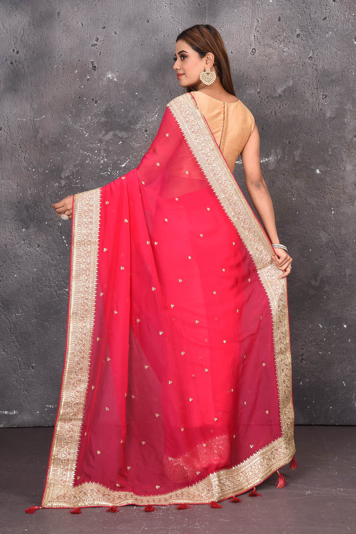 Shop exquisite pink georgette banarasi designer saree with golden heavy Border online in USA which has crafted by skilled weaver of Banaras with elegance and grace, this saree is definitely the epitome of beauty and a must have in your collection. Buy designer handwoven banarasi georgette sari with any blouse from Pure Elegance Indian saree store in USA.-Back view with open pallu.