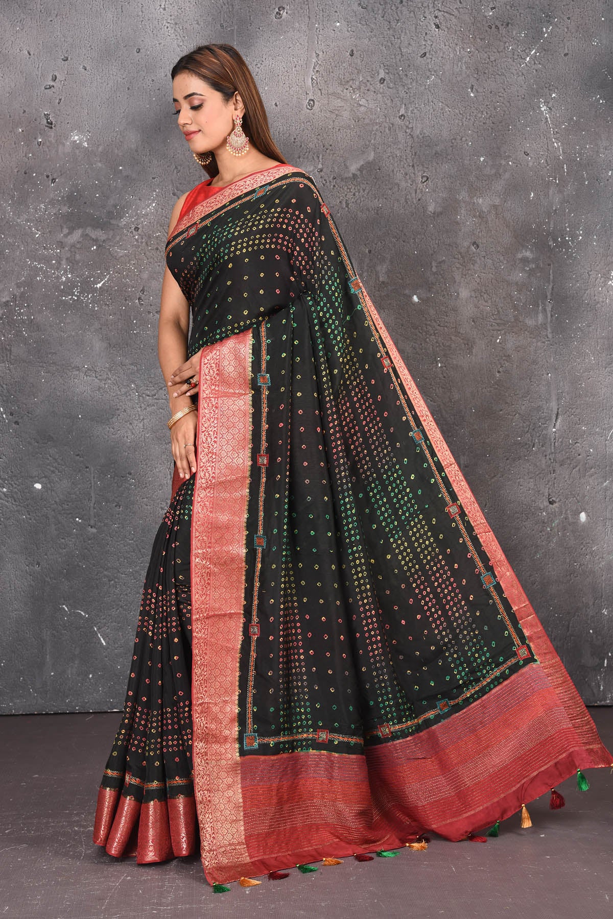 Buy this royal black banarasi pure muga silk saree with red-golden zari work online in USA. An enchanting black with scintillating palla and border. This muga silk brings the charm and simplicity of this black saree with border and pallu with the delegate zari work on border. Shop this designer silk sari from Pure Elegance Indian fashion store in USA.-Side view with open pallu.