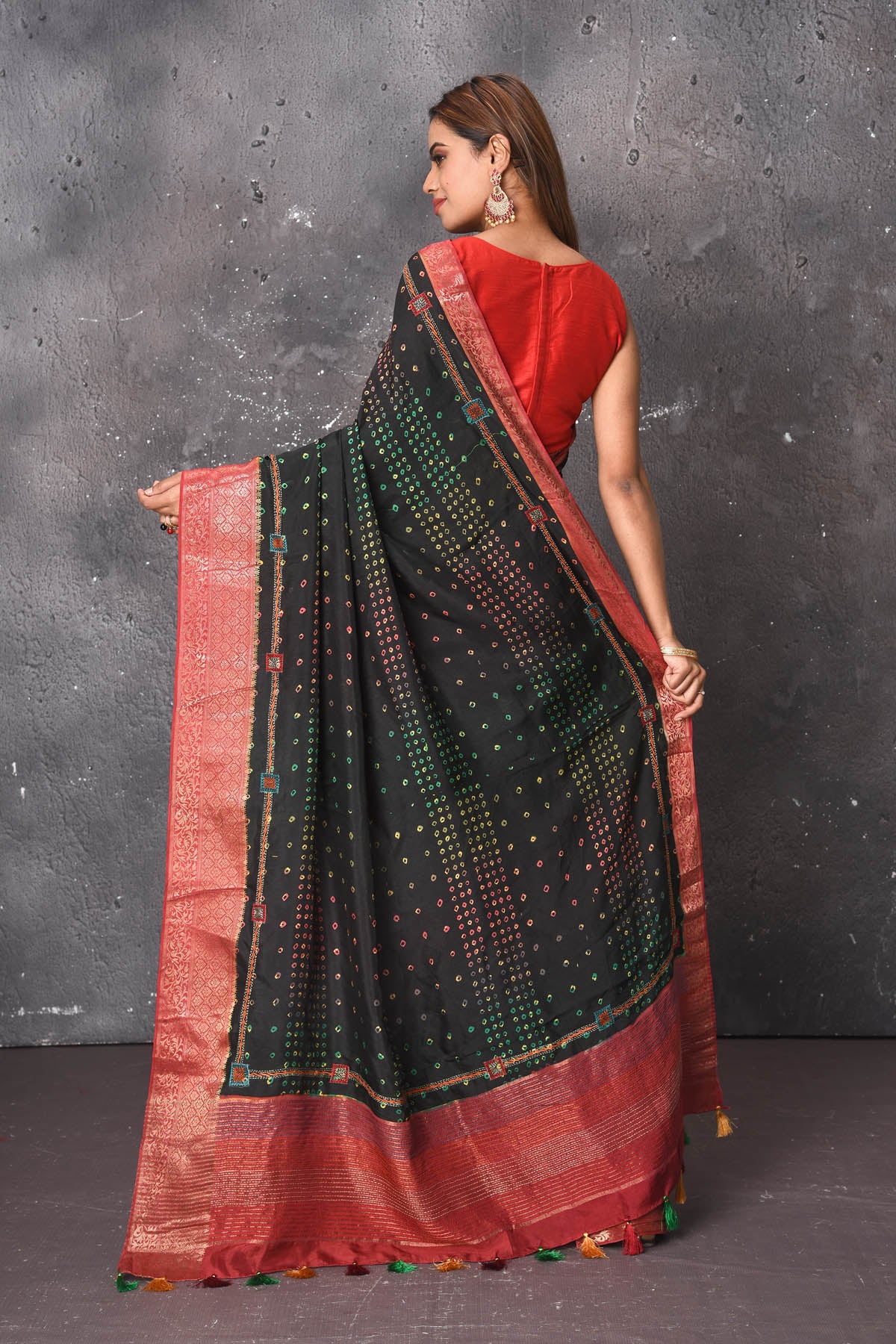 Buy this royal black banarasi pure muga silk saree with red-golden zari work online in USA. An enchanting black with scintillating palla and border. This muga silk brings the charm and simplicity of this black saree with border and pallu with the delegate zari work on border. Shop this designer silk sari from Pure Elegance Indian fashion store in USA.-Back open with open pallu.