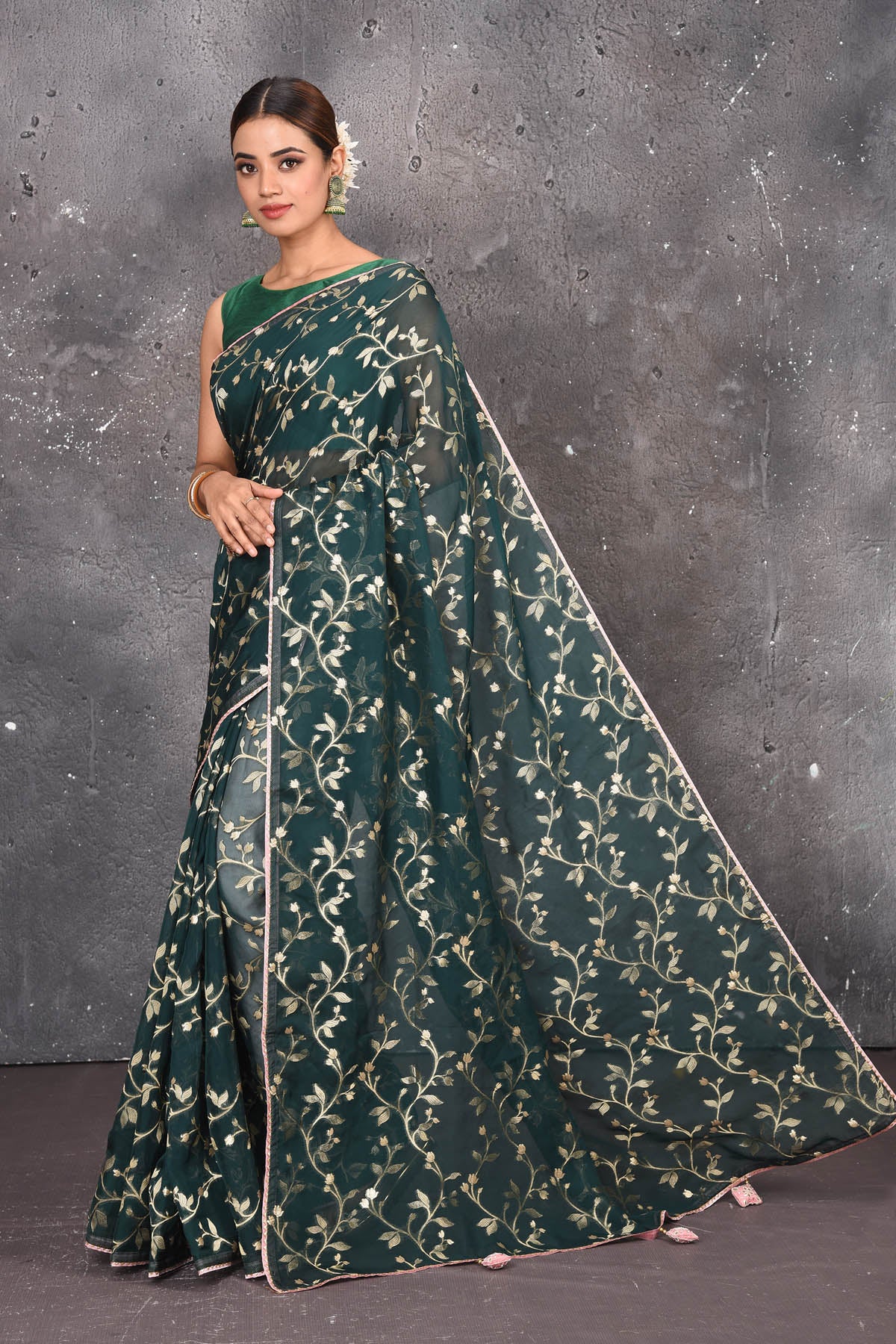 Buy exquisite dark green kora silk designer saree with floral jaal print online in USA. Pure kora sarees by Pure Elegance in green color. It has a beautiful floral jaal print all over. This kora brings the charm and simplicity of this saree with border and pallu. Shop this designer silk sari from Pure Elegance Indian fashion store in USA.-Full view with folded hands.