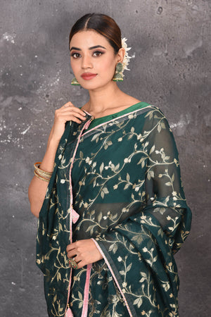 Buy exquisite dark green kora silk designer saree with floral jaal print online in USA. Pure kora sarees by Pure Elegance in green color. It has a beautiful floral jaal print all over. This kora brings the charm and simplicity of this saree with border and pallu. Shop this designer silk sari from Pure Elegance Indian fashion store in USA.-Close up.