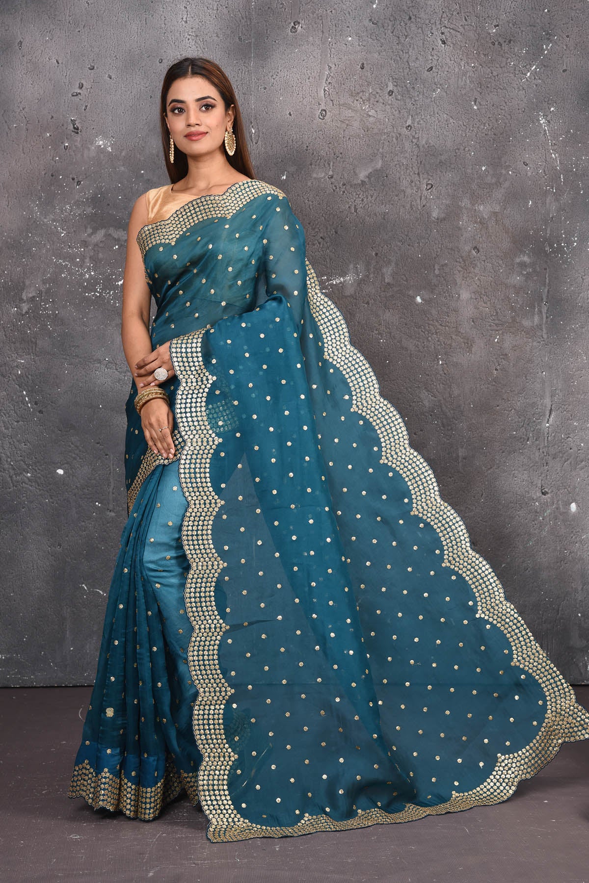 Buy exquisite blue organza saree with golden embroidered online in USA. Pure organza sarees by Pure Elegance in blue color. It has a beautiful gold embroidered border. This organza brings the charm and simplicity of this saree with border and pallu with the delegate embroidery work on border. Shop this designer silk sari from Pure Elegance Indian fashion store in USA.-Full view.