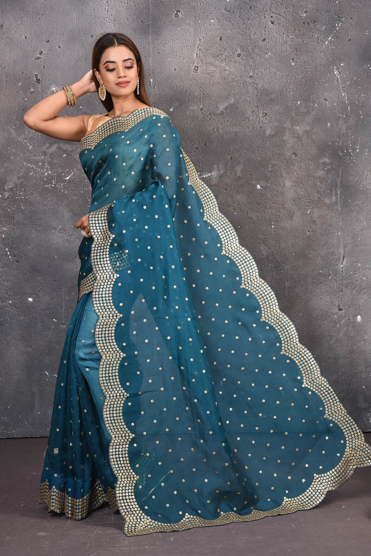 Buy exquisite blue organza saree with golden embroidered online in USA. Pure organza sarees by Pure Elegance in blue color. It has a beautiful gold embroidered border. This organza brings the charm and simplicity of this saree with border and pallu with the delegate embroidery work on border. Shop this designer silk sari from Pure Elegance Indian fashion store in USA.-Full view with open pallu.