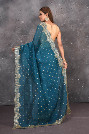 Buy exquisite blue organza saree with golden embroidered online in USA. Pure organza sarees by Pure Elegance in blue color. It has a beautiful gold embroidered border. This organza brings the charm and simplicity of this saree with border and pallu with the delegate embroidery work on border. Shop this designer silk sari from Pure Elegance Indian fashion store in USA.-Back open with open pallu.