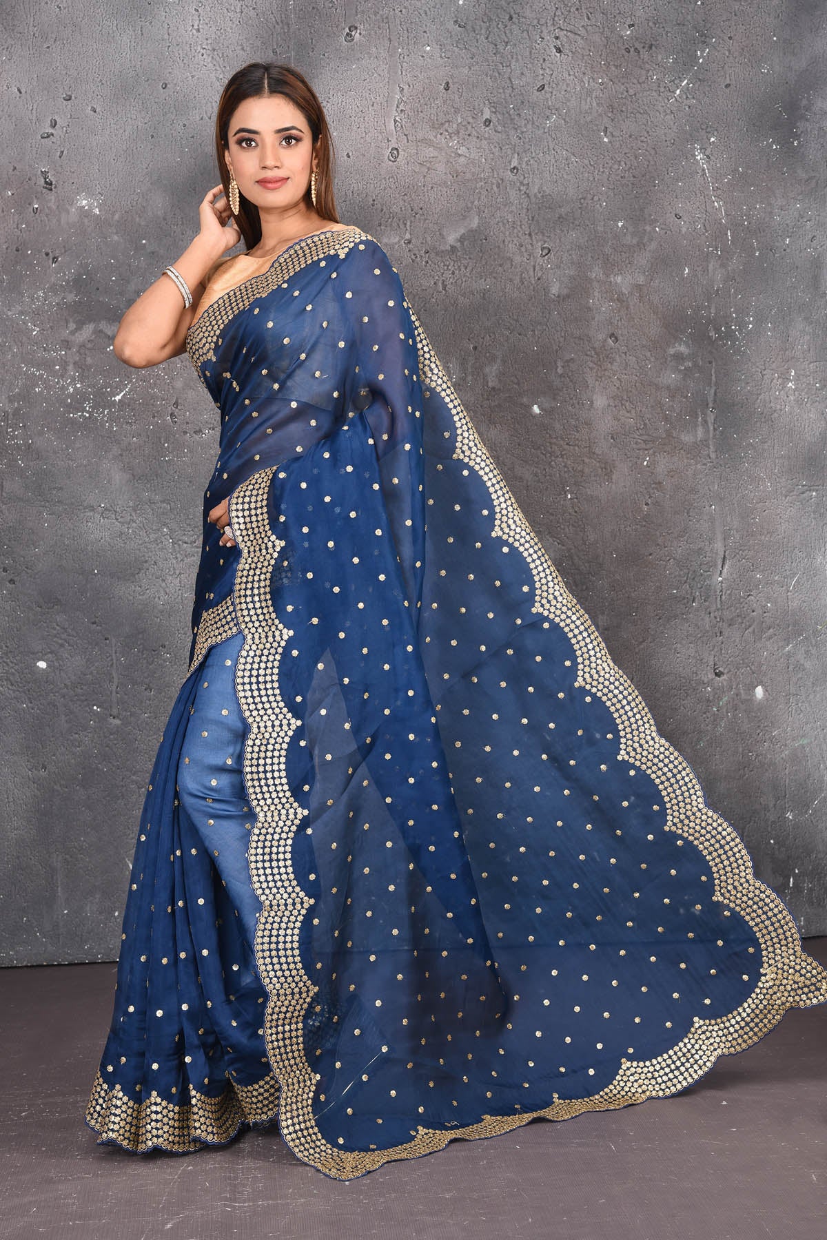 Buy exquisite navy blue organza saree with golden embroidered online in USA. Pure organza sarees by Pure Elegance in blue color. It has a beautiful gold embroidered border. This organza brings the charm and simplicity of this saree with border and pallu with the delegate embroidery work on border. Shop this designer silk sari from Pure Elegance Indian fashion store in USA.-Full view. 