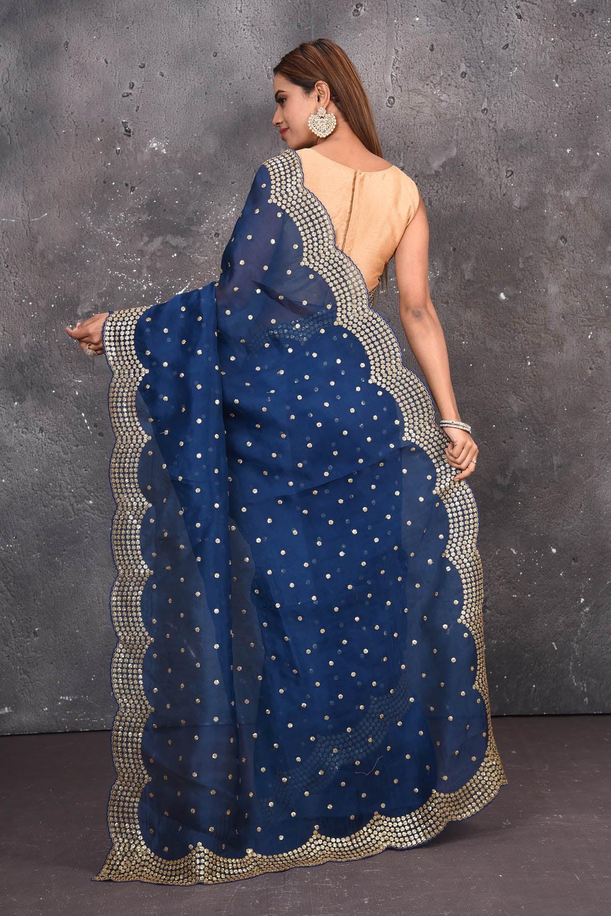 Buy exquisite navy blue organza saree with golden embroidered online in USA. Pure organza sarees by Pure Elegance in blue color. It has a beautiful gold embroidered border. This organza brings the charm and simplicity of this saree with border and pallu with the delegate embroidery work on border. Shop this designer silk sari from Pure Elegance Indian fashion store in USA.-Back view with open pallu.