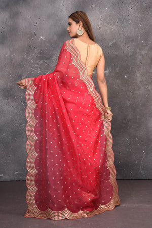 Buy exquisite pink organza saree with golden embroidered online in USA. Pure organza sarees by Pure Elegance in pink color. It has a beautiful gold embroidered border. This organza brings the charm and simplicity of this saree with border and pallu with the delegate embroidery work on border. Shop this designer silk sari from Pure Elegance Indian fashion store in USA.-Back view with open pallu.