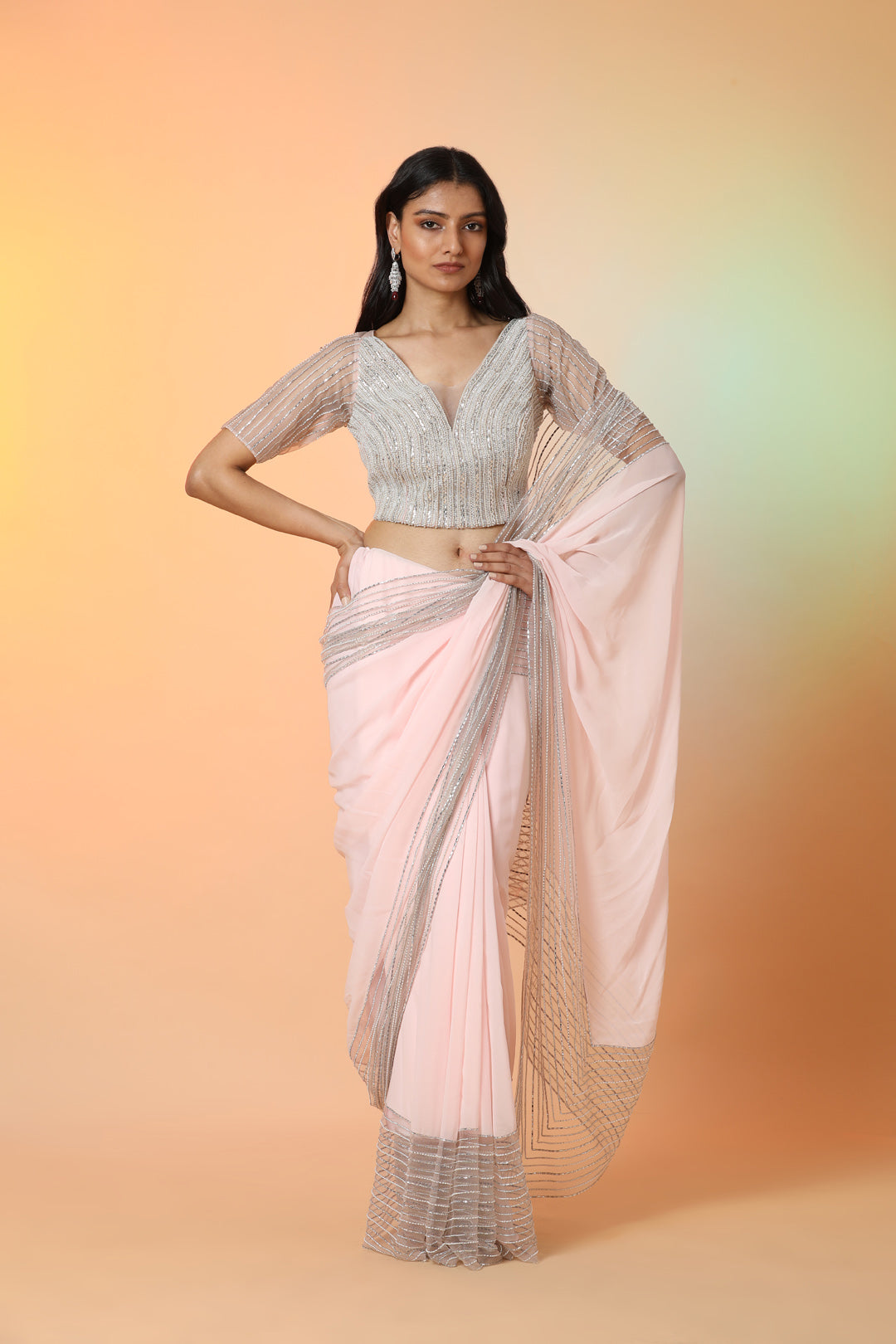 Buy beautiful powder pink georgette designer saree online in USA with blouse. Radiate glamor on special occasions in exquisite designer sarees, embroidered sarees, partywear saris, Bollywood sarees, fancy sarees from from Pure Elegance Indian saree store in USA.-front