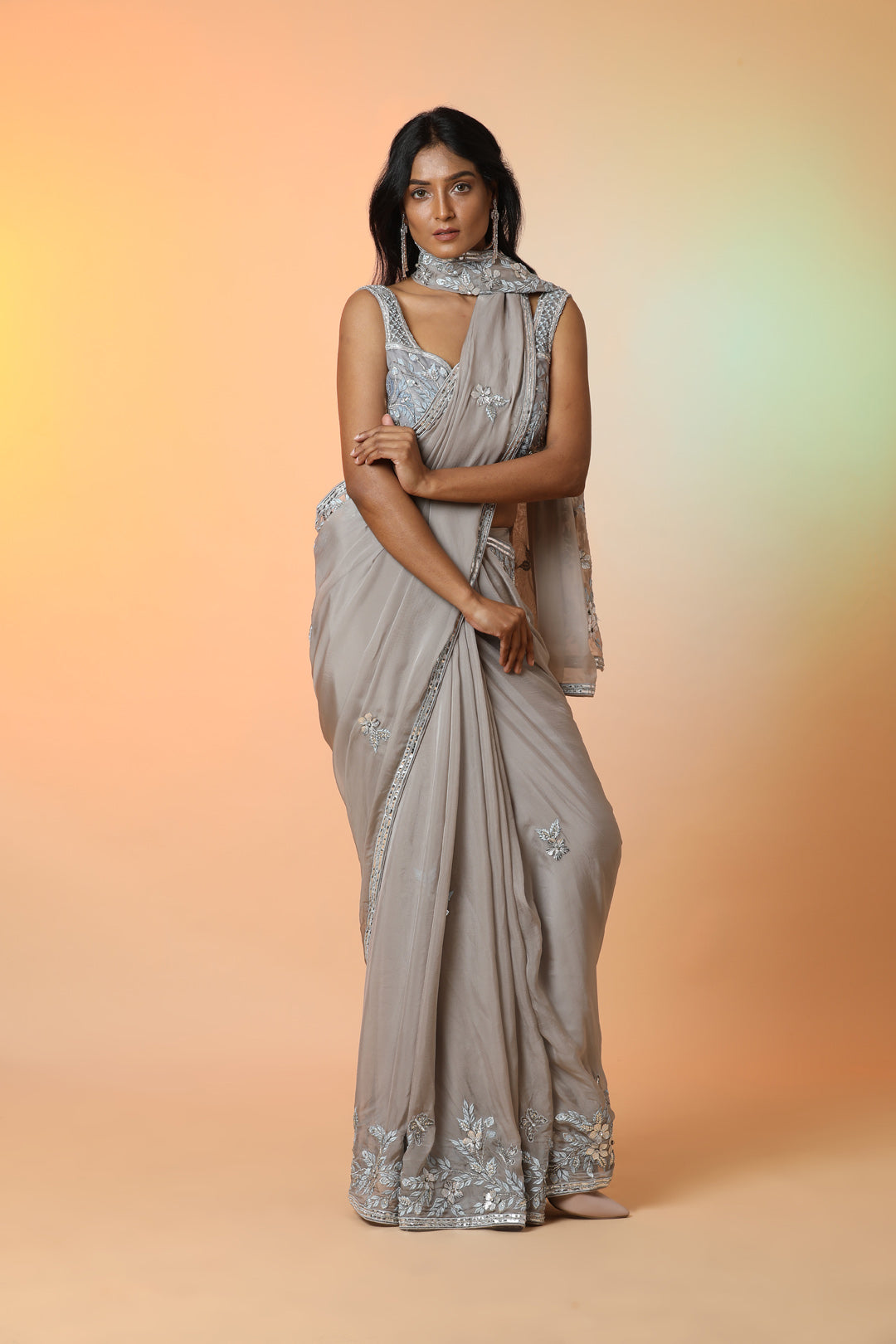 Buy beautiful grey embroidered crepe designer saree online in USA with blouse. Radiate glamor on special occasions in exquisite designer sarees, embroidered sarees, partywear saris, Bollywood sarees, fancy sarees from from Pure Elegance Indian saree store in USA.-front
