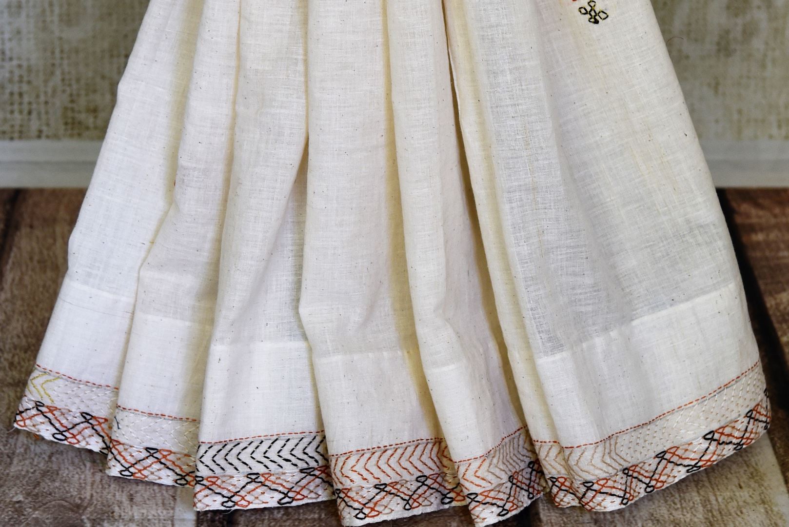 Shop stunning cream Kantha stitch linen saree online in USA. Look elegant on special occasions in beautiful printed sarees, silk sarees, tussar sarees, handloom sarees, Kanchipuram sarees from Pure Elegance Indian saree store in USA.-pleats