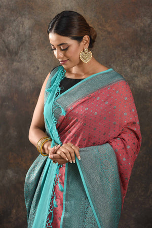 Buy beautiful pink georgette saree online in USA with antique zari blue border. Be vision of elegance on special occasions in exquisite designer sarees, handwoven sarees, georgette sarees, embroidered sarees, Banarasi sarees from Pure Elegance Indian saree store in USA.-closeup