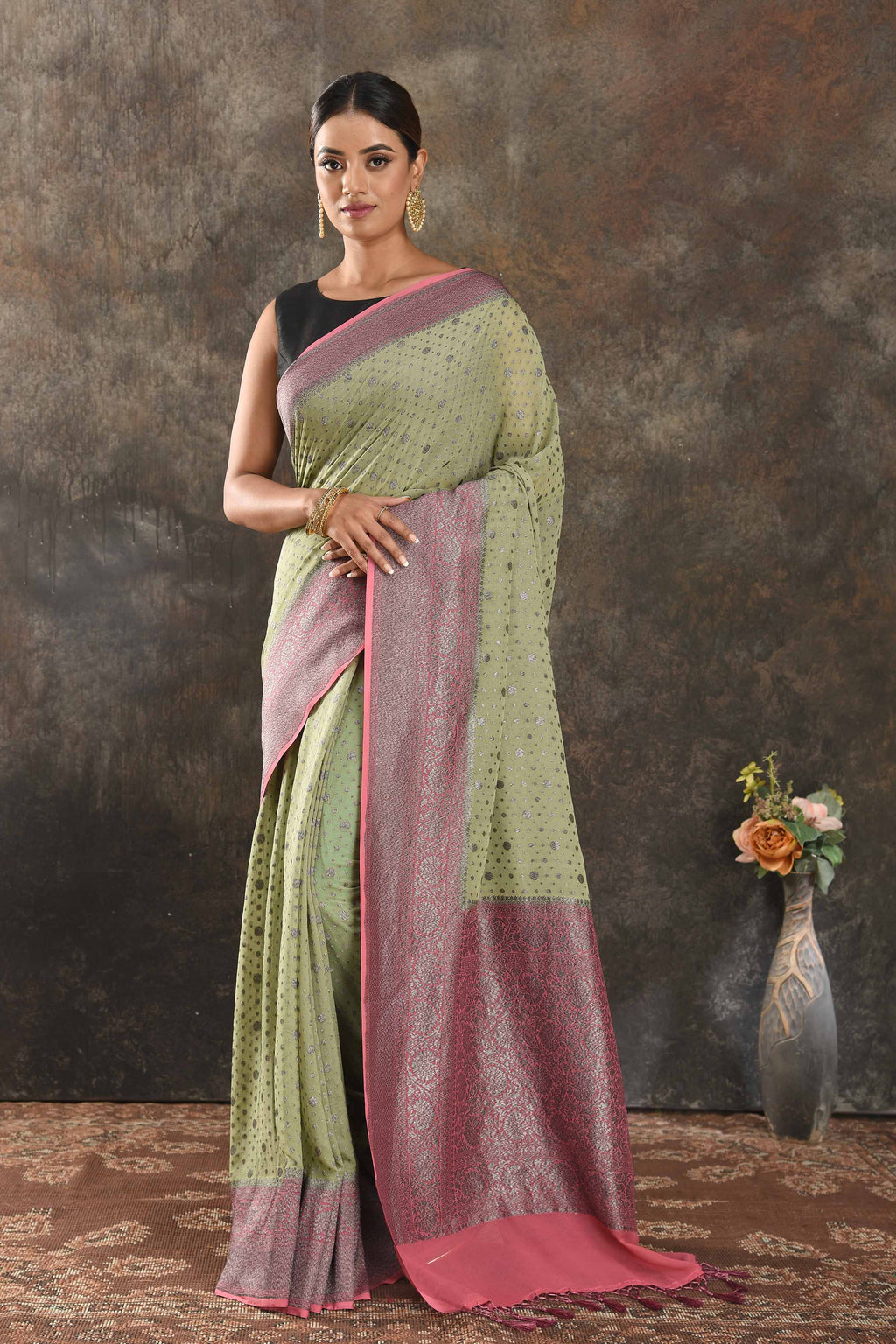 Buy stunning pastel green georgette saree online in USA with antique zari pink border. Be vision of elegance on special occasions in exquisite designer sarees, handwoven sarees, georgette sarees, embroidered sarees, Banarasi sarees from Pure Elegance Indian saree store in USA.-full view