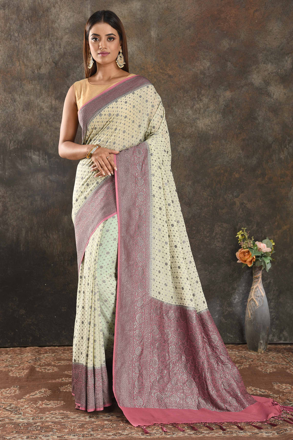 Shop stunning cream georgette sari online in USA with antique zari pink border. Be vision of elegance on special occasions in exquisite designer sarees, handwoven sarees, georgette sarees, embroidered sarees, Banarasi sarees from Pure Elegance Indian saree store in USA.-full view