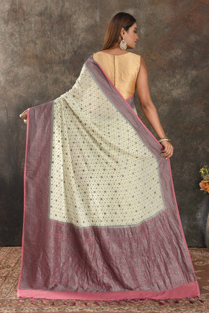 Shop stunning cream georgette sari online in USA with antique zari pink border. Be vision of elegance on special occasions in exquisite designer sarees, handwoven sarees, georgette sarees, embroidered sarees, Banarasi sarees from Pure Elegance Indian saree store in USA.-back