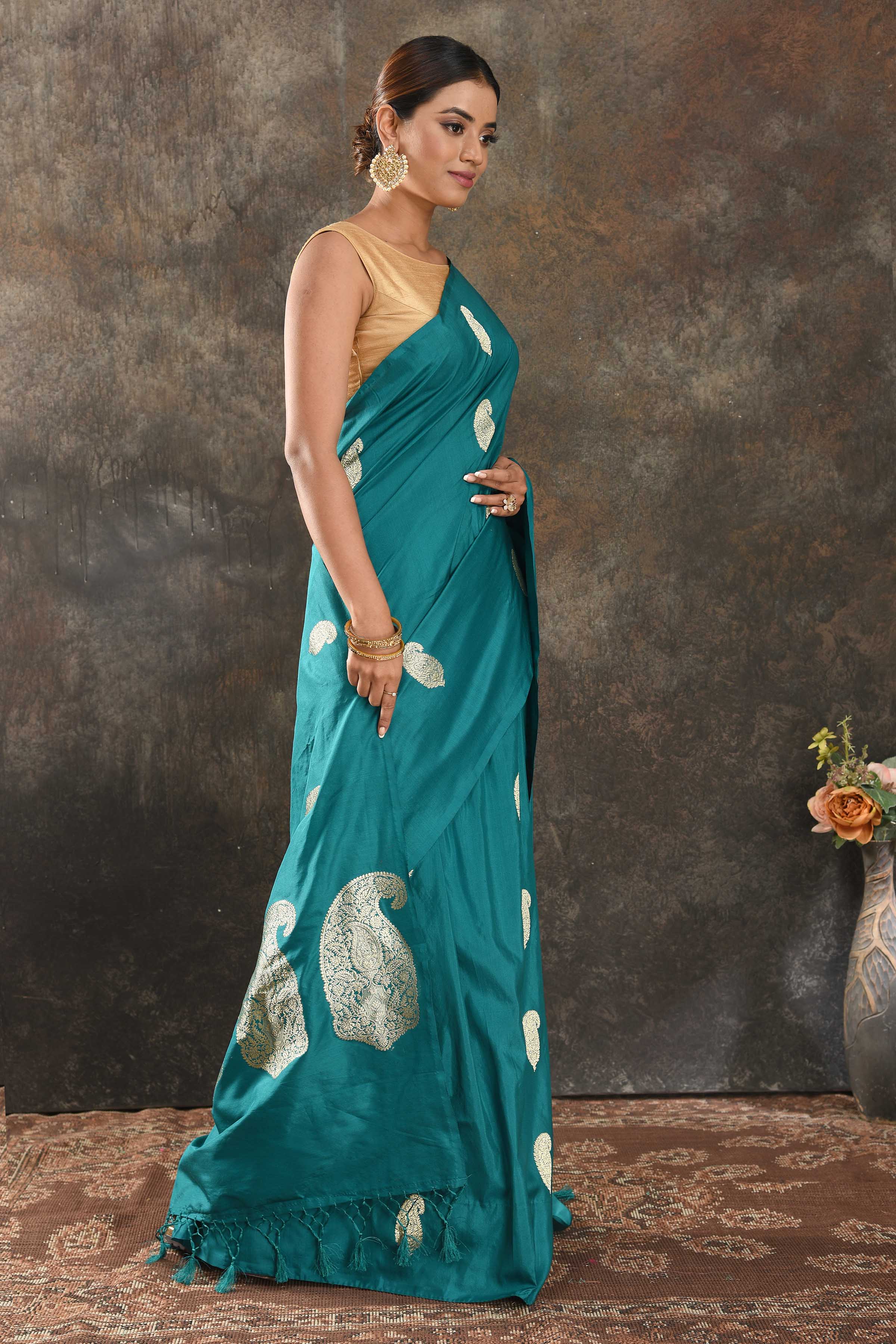 Shop sea green silk sari online in USA with silver zari paisley buta. Be vision of elegance on special occasions in exquisite designer sarees, handwoven sarees, georgette sarees, embroidered sarees, Banarasi sarees from Pure Elegance Indian saree store in USA.-side