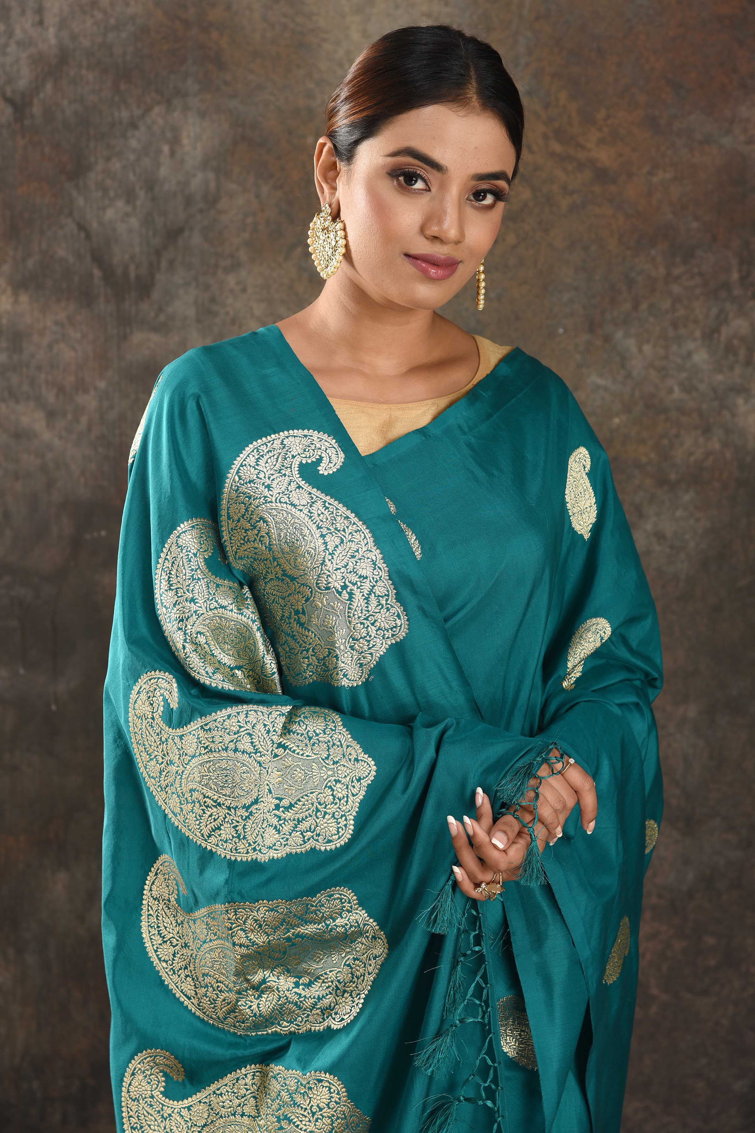 Shop sea green silk sari online in USA with silver zari paisley buta. Be vision of elegance on special occasions in exquisite designer sarees, handwoven sarees, georgette sarees, embroidered sarees, Banarasi sarees from Pure Elegance Indian saree store in USA.-closeup