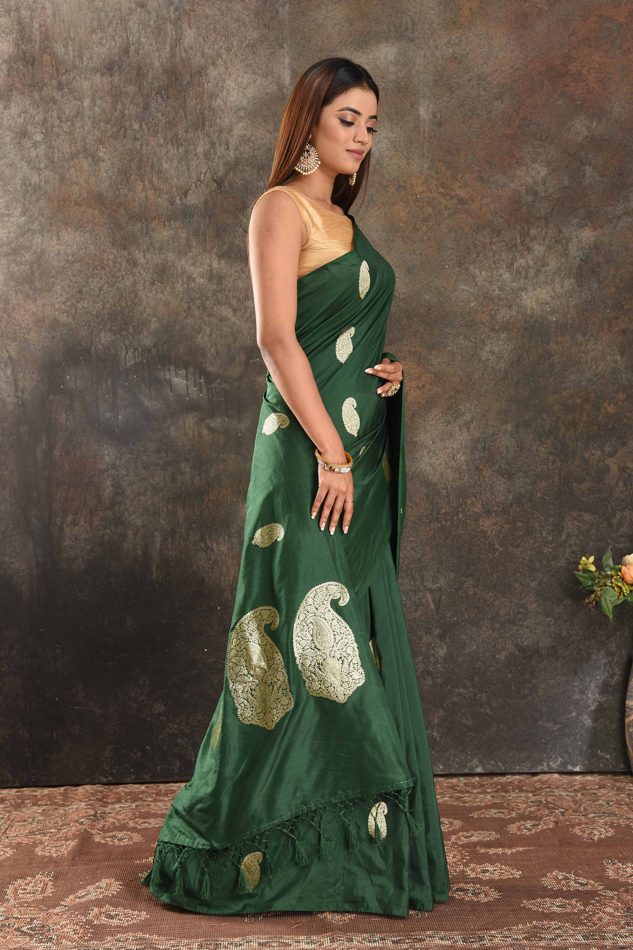 Buy stunning dark green silk saree online in USA with silver zari paisley buta. Be vision of elegance on special occasions in exquisite designer sarees, handwoven sarees, georgette sarees, embroidered sarees, Banarasi sarees from Pure Elegance Indian saree store in USA.-side