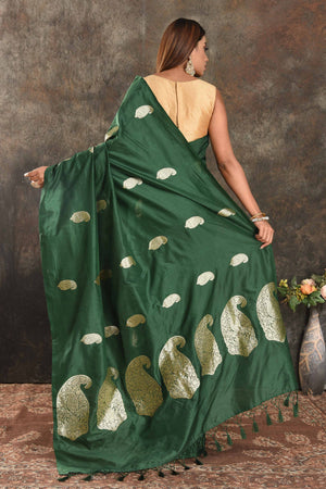Buy stunning dark green silk saree online in USA with silver zari paisley buta. Be vision of elegance on special occasions in exquisite designer sarees, handwoven sarees, georgette sarees, embroidered sarees, Banarasi sarees from Pure Elegance Indian saree store in USA.-back